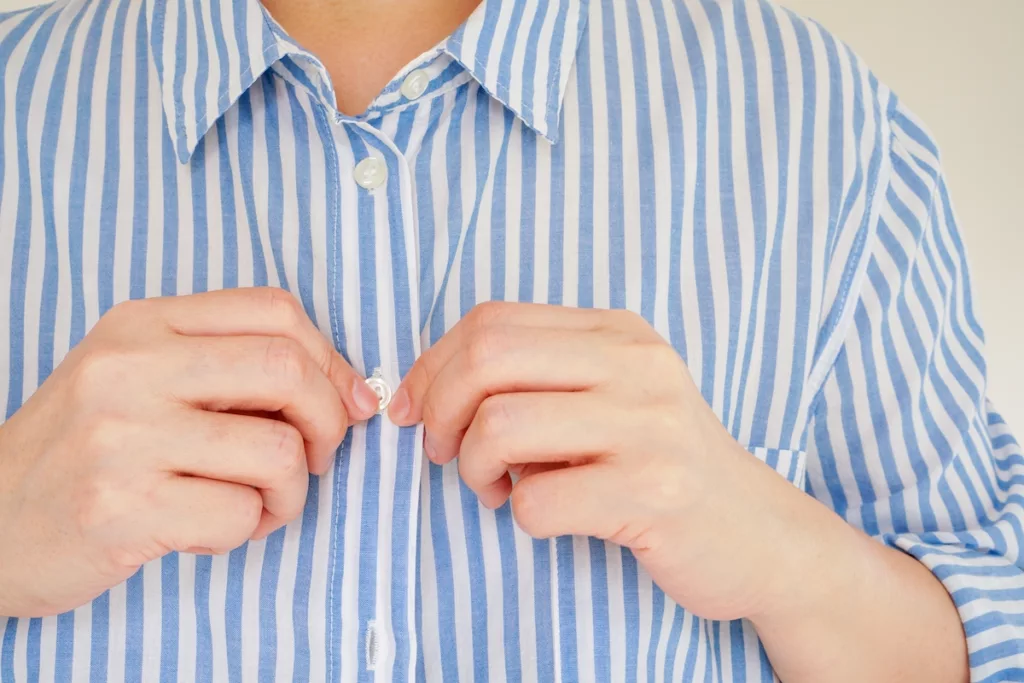 Man Fastening Button on Shirt_What Are ADLs