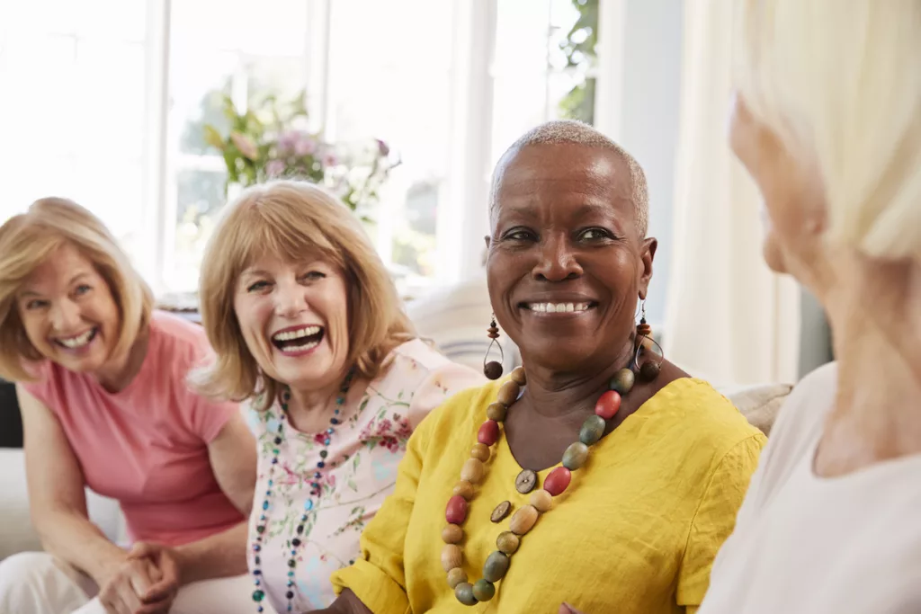 Group of Laughing Senior Women Socializing on Couch_Ormond Beach Senior Living