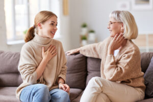 Senior Woman and Adult Daughter Talk on Couch_Aden Senior Living