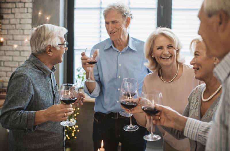 seniors celebrating with wine Aden senior living open house