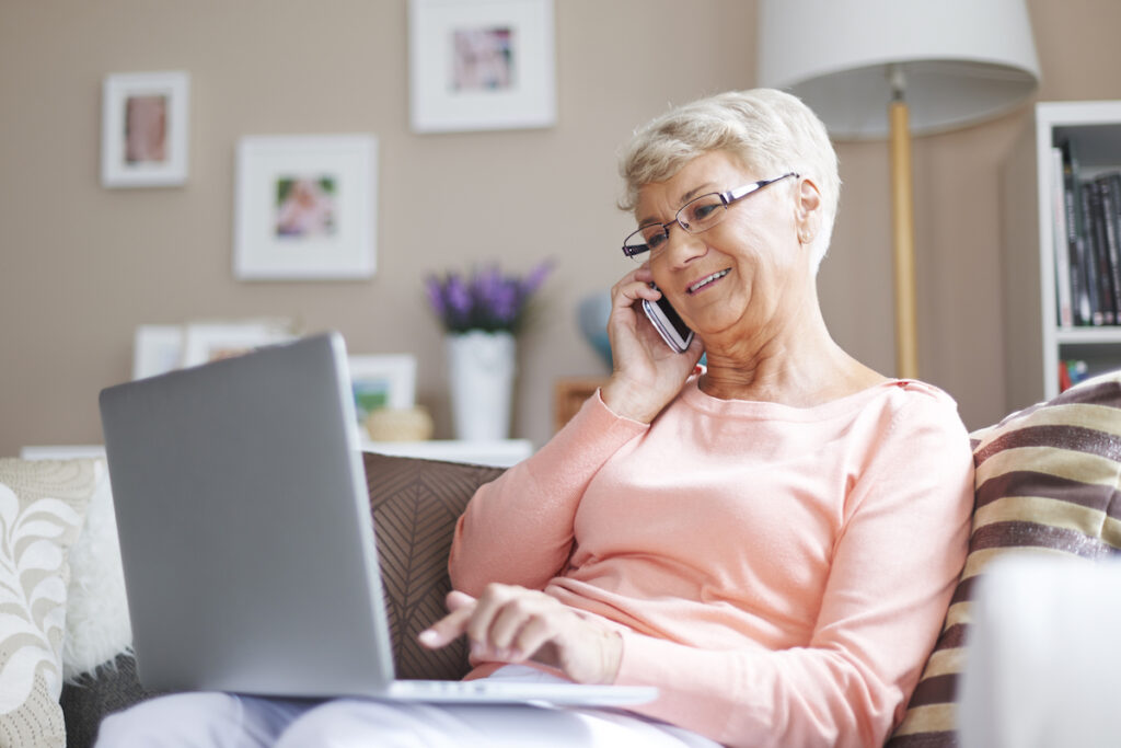 Senior Woman Using Laptop and Phone_Maintaining Independence